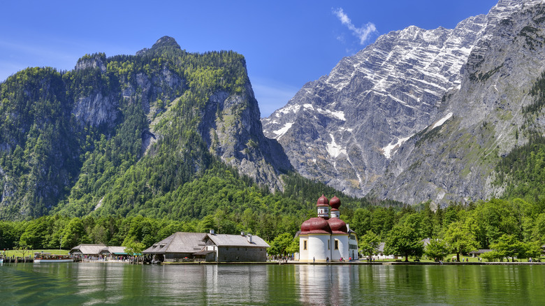 a red-domed church sits on the shores of Lake Königssee