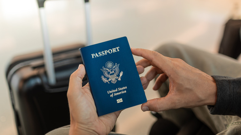 Traveler with closeup of USA passport
