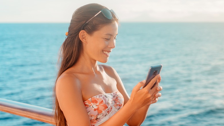 Woman using phone on cruise ship