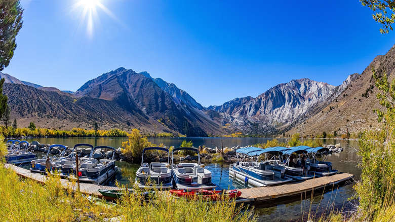 Boats on a dock on Convict Lake with mountains in the background
