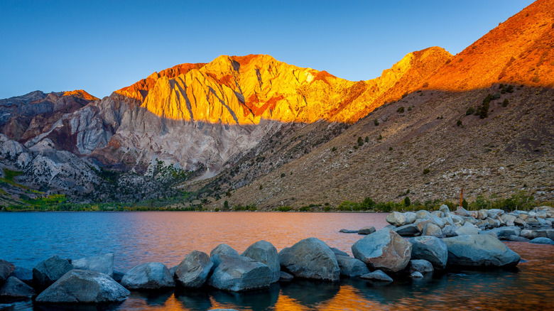 Sunset reflecting off mountains near a lake