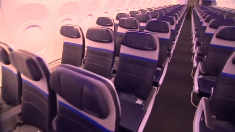 A single aisle runs between the seats of the new United Airbus.