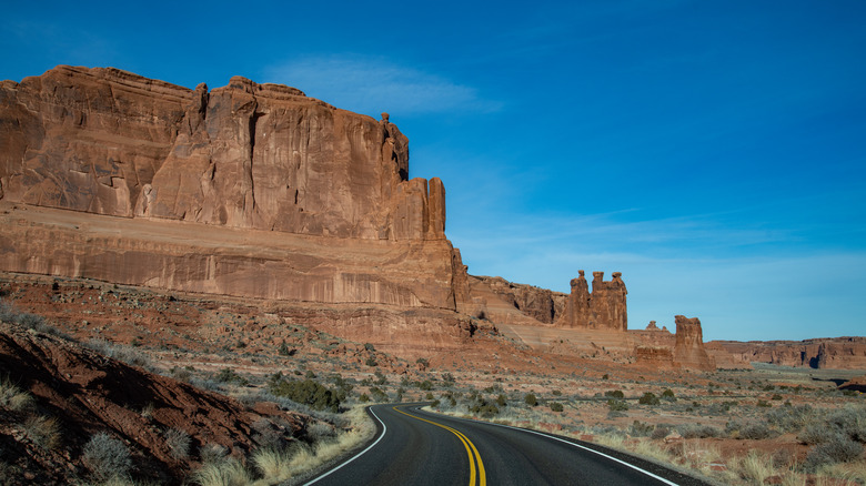 A highway curving through red rock formations in Utah