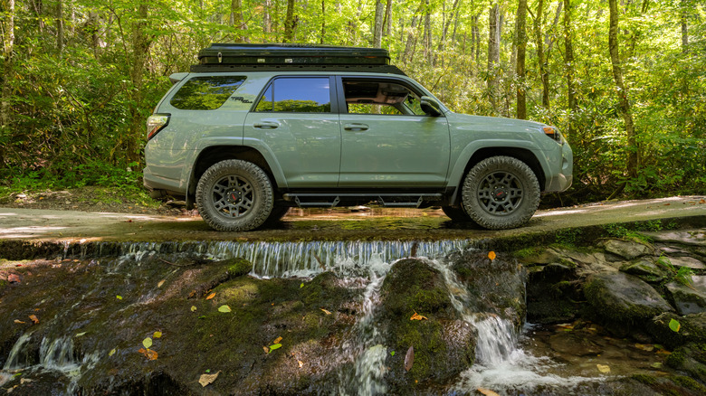 Car drives over creek