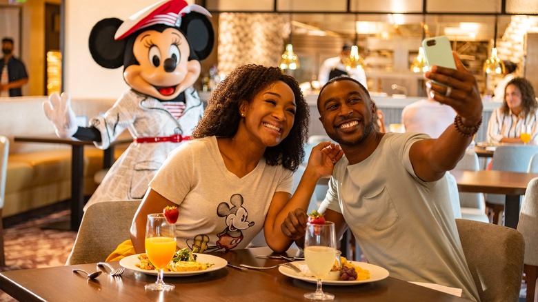 Couple taking selfie with Minnie Mouse