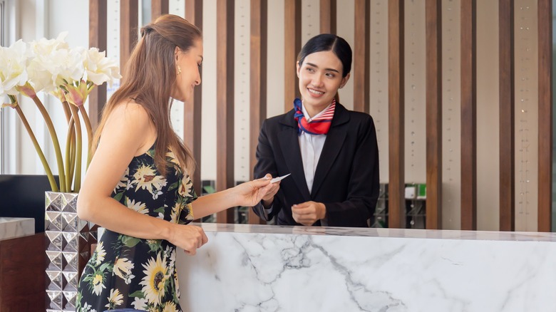 Woman checking into a hotel