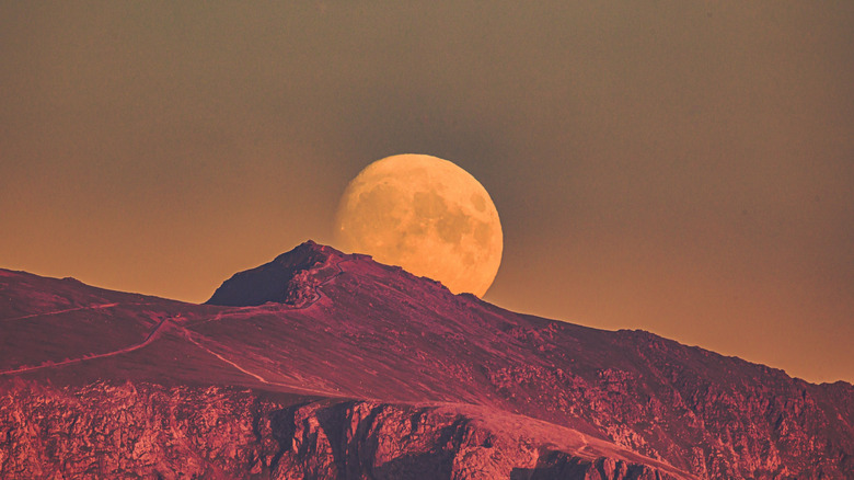 supermoon rising over mountains