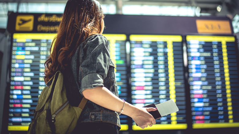 woman looking at flight board