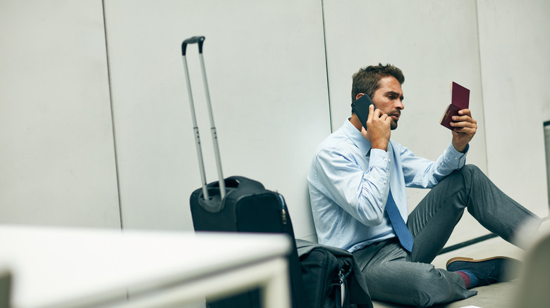 traveler making phone call with passport