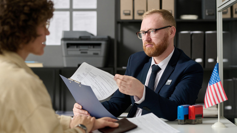 government official helping person apply for passport