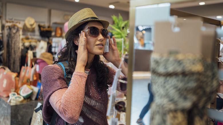 Woman looking at herself in an airport mirror