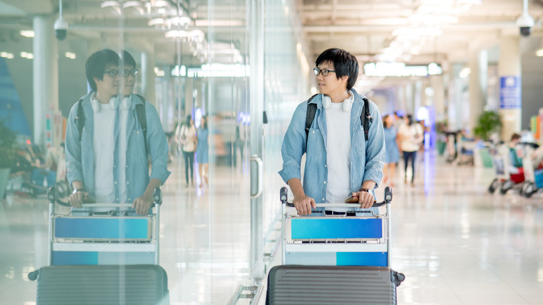 Man looking in an airport mirror