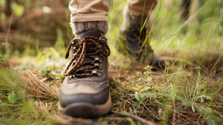 Close-up of hiking boots on ground
