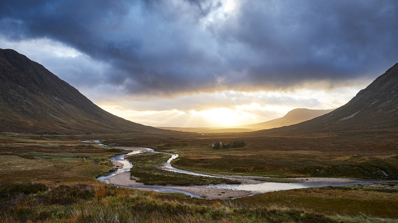 Glen Coe at sunrise with a river in the foreground