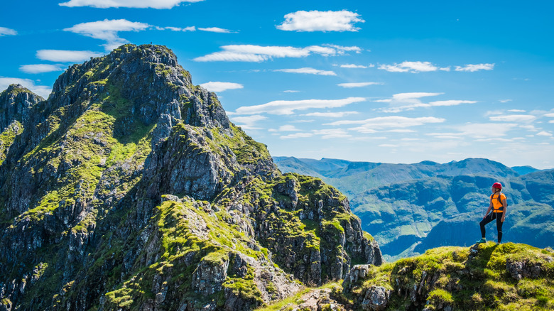 Climber looking over the peaks of the Aonach Eagach ridge