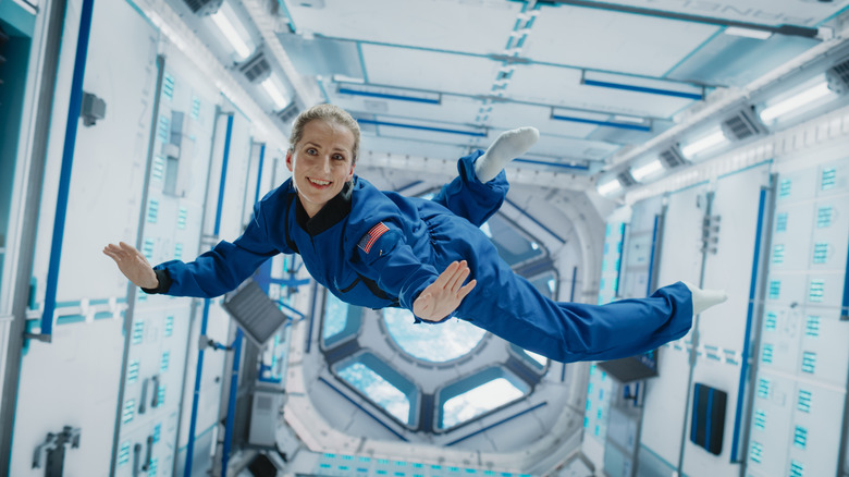 Female astronaut floats in zero gravity in space