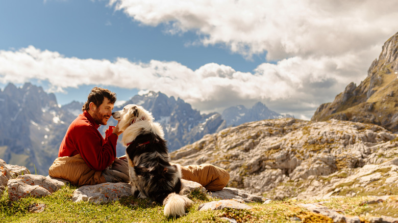 A man and his dog on a mountaintop