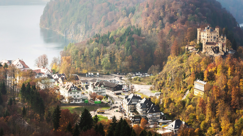 the village of Hohenschwangau along Alpsee, a lake in Bavaria, with Hohenschwangau Castle on the hillside in Germany
