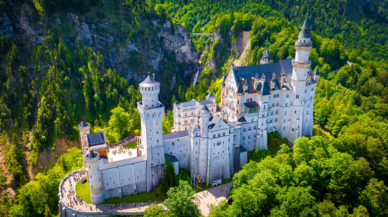 Neuschwanstein Castle perched on a hill above the village of Hohenschwangau and Alpsee in Bavaria, Germany