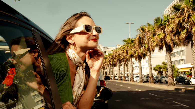 A woman with a vintage aesthetic driving in LA.