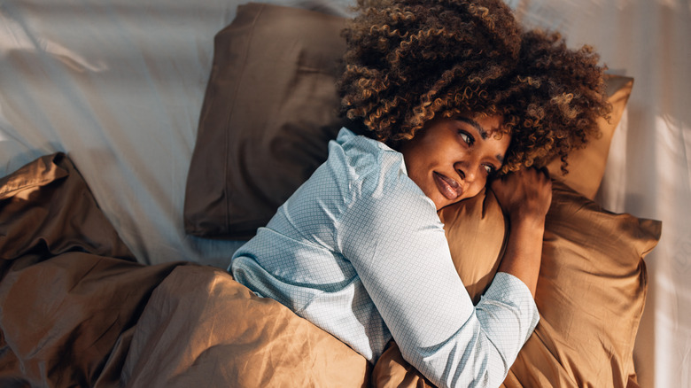 smiling woman in bed