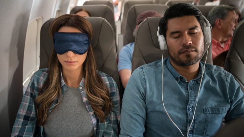passengers sleeping on plane