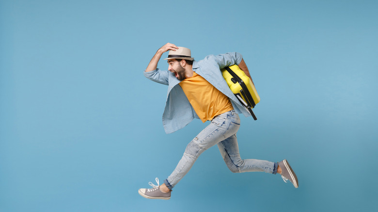 Man running with suitcase