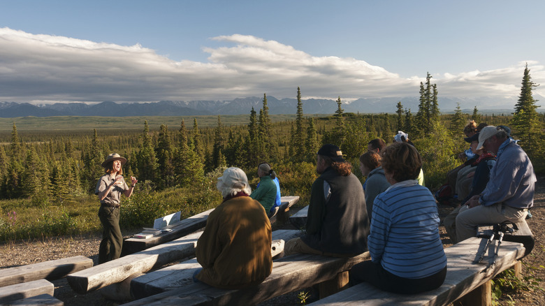 ranger giving talk to seated audience in nature