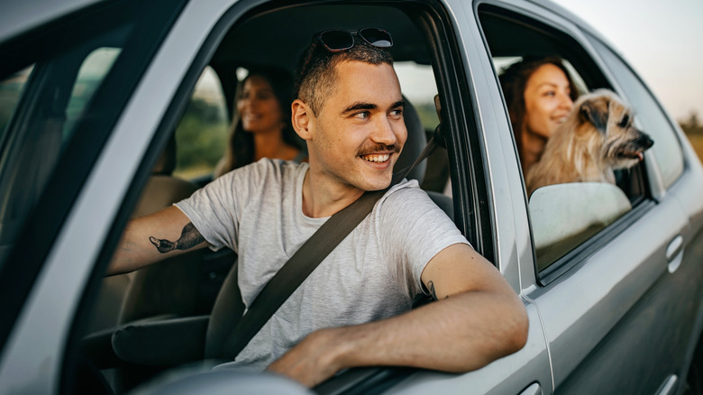 friends enjoying road trip in car