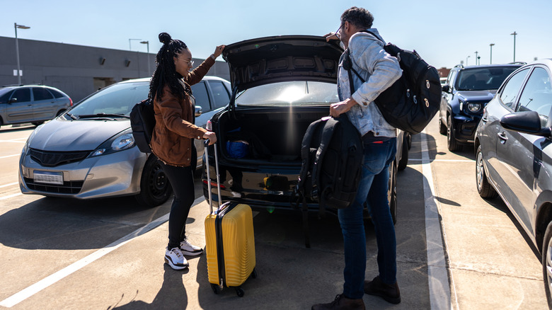 two travelers in parking lot