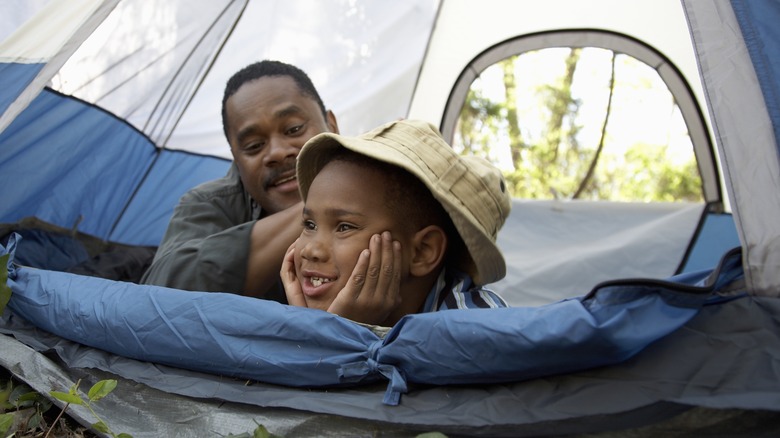 father and son in a tent