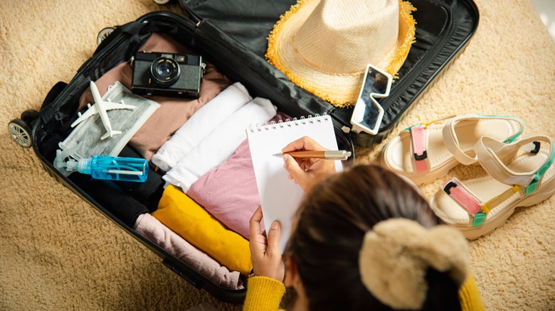 Woman packing small suitcase