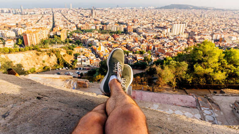POV shot of feet on a ledge overlooking city