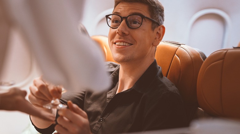Man smiling at cabin crew