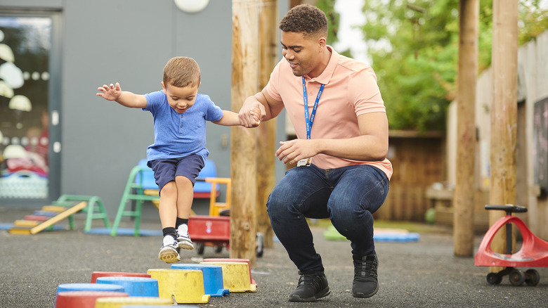 Nursery worker babysitting a child