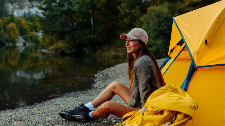Woman sitting outside yellow tent