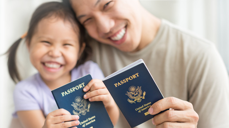 father and daughter with passports