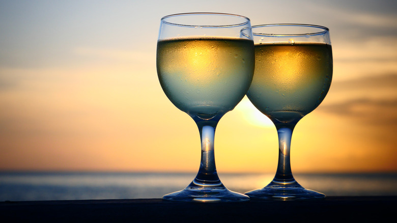 Two glasses of wine at sunset 