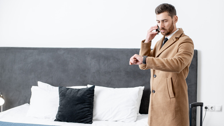 man leaving hotel room