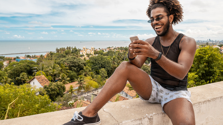 man looking happily at phone