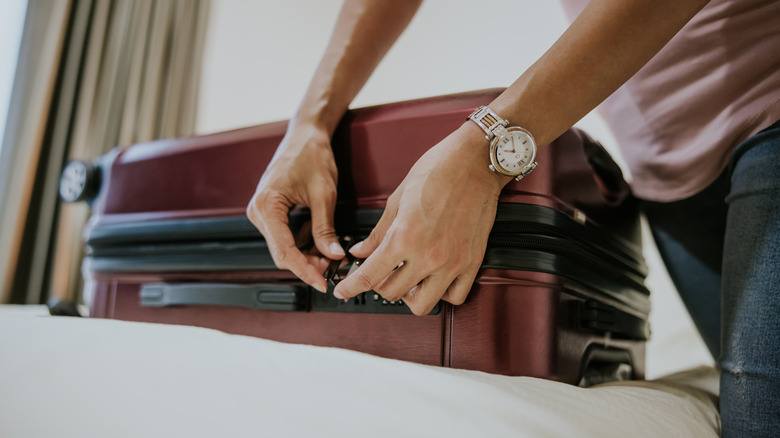 hands with luggage lock