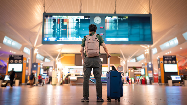 Passenger checking an airport screen