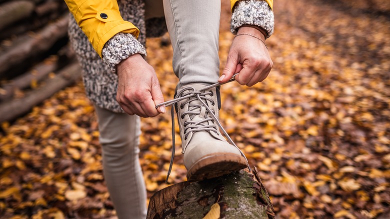 person tying their boot laces