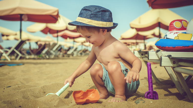 Little boy with beach toys