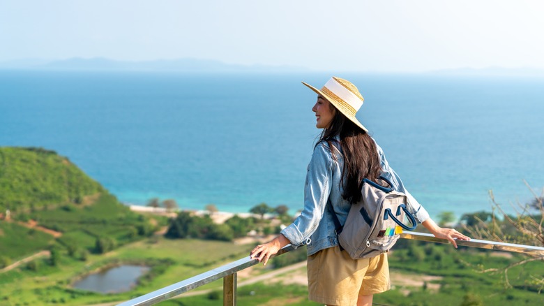 woman enjoying view ocean grass