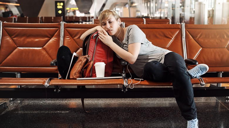 woman sleeping in airport terminal 