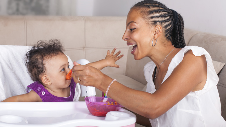 Baby eating in highchair