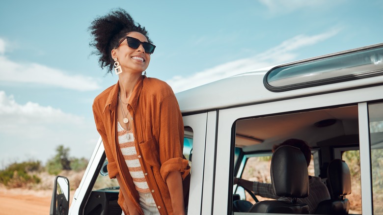 woman leaning out of vehicle