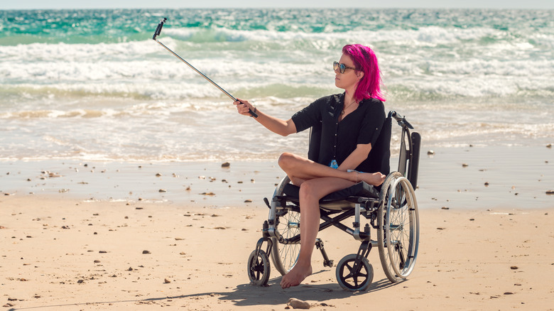 Woman in wheelchair taking selfie