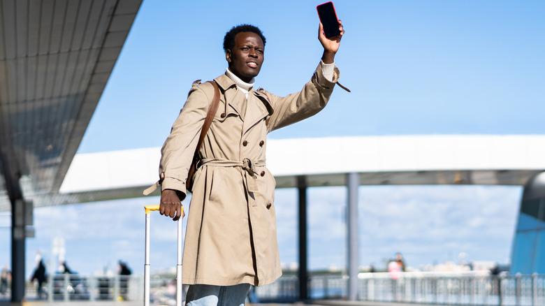 Man waiting for ride-share at airport